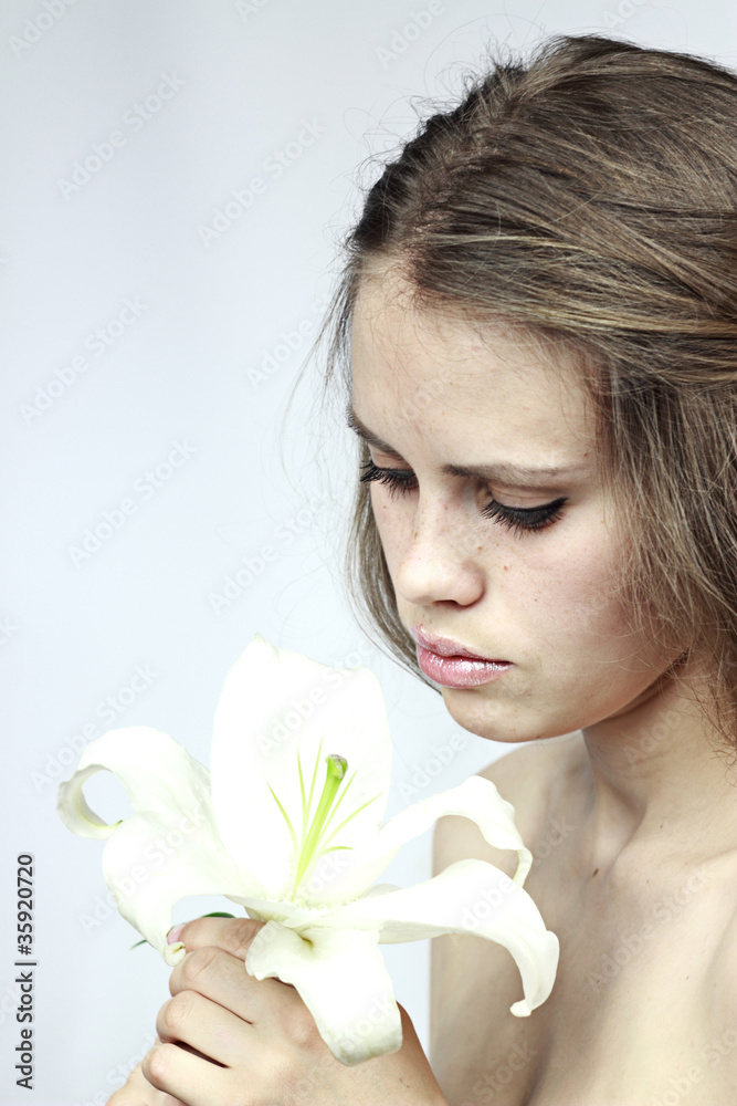girl looks at a white flower girl looks at a white flower