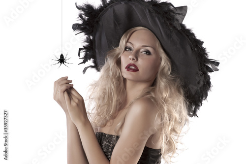 portrait of beautiful witch wearing a huge hat