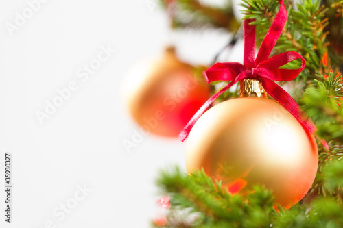Tableau sur toile Christmas Ornament with Lighted Tree in Background, Copy Space
