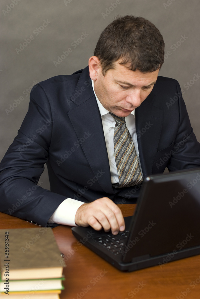 Pensive face businessman sitting at computer Pensive face businessman sitting at computer