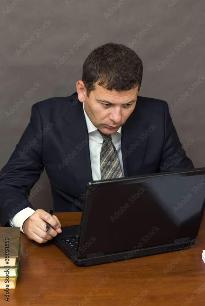 Pensive face businessman sitting at computer Pensive face businessman sitting at computer