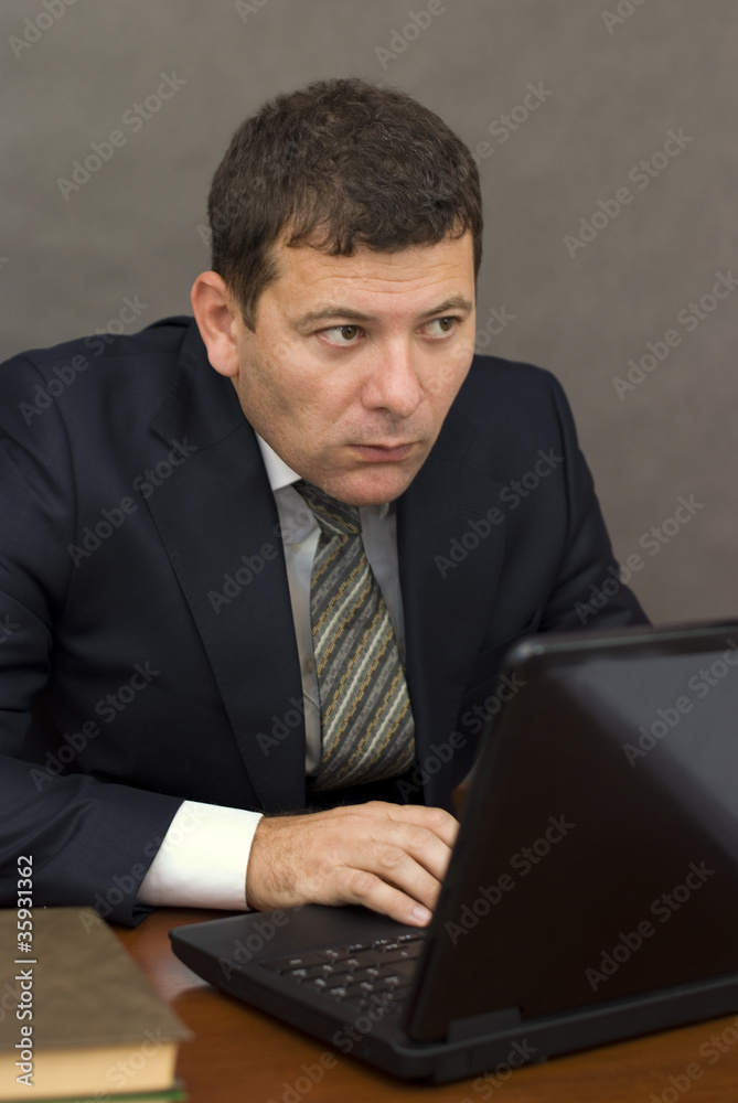 Pensive face businessman sitting at computer Pensive face businessman sitting at computer