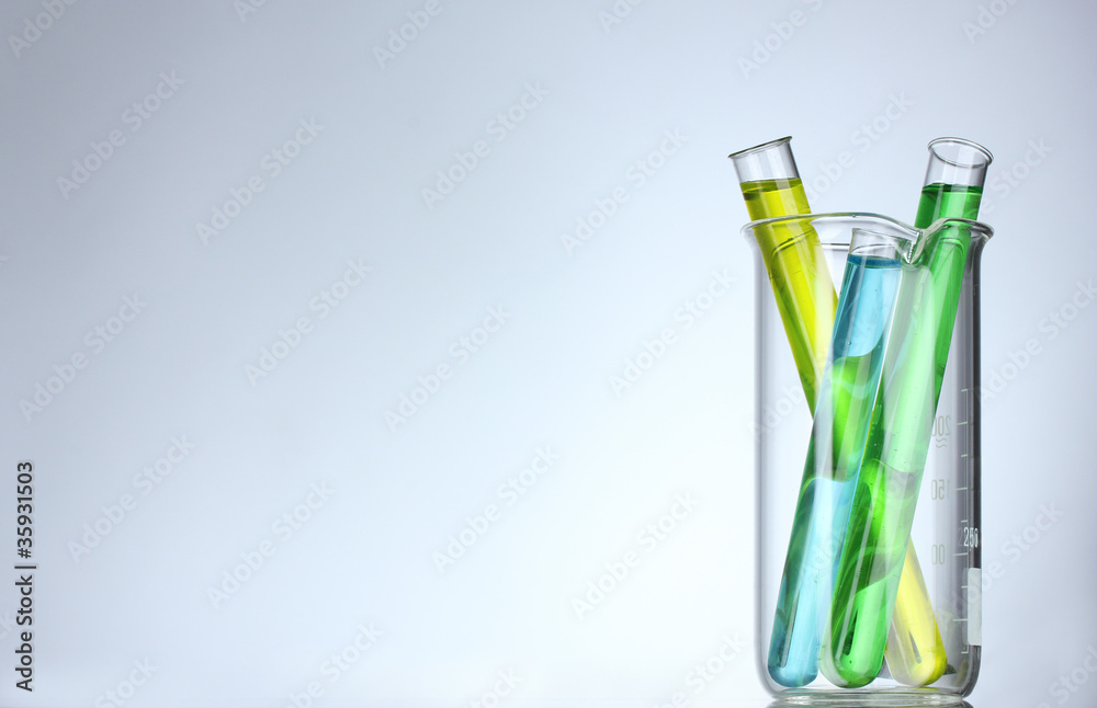 Test-tubes with liquid on gray background Test-tubes with liquid on gray background