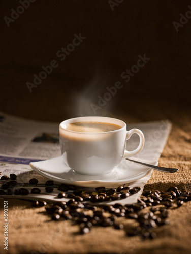 warm cup of coffee on brown background