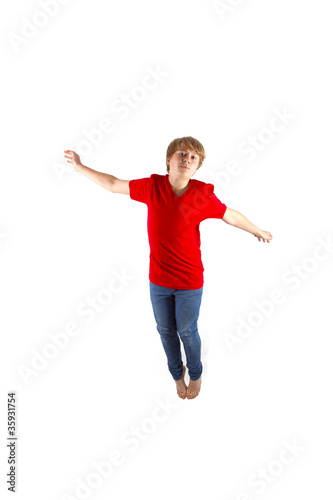 smart boy with red shirt jumping in the air