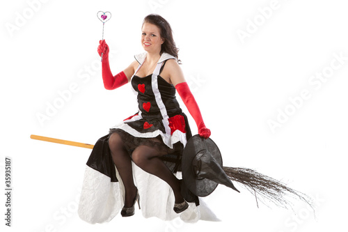 smiling girl in Halloween witch flying on a broom photo