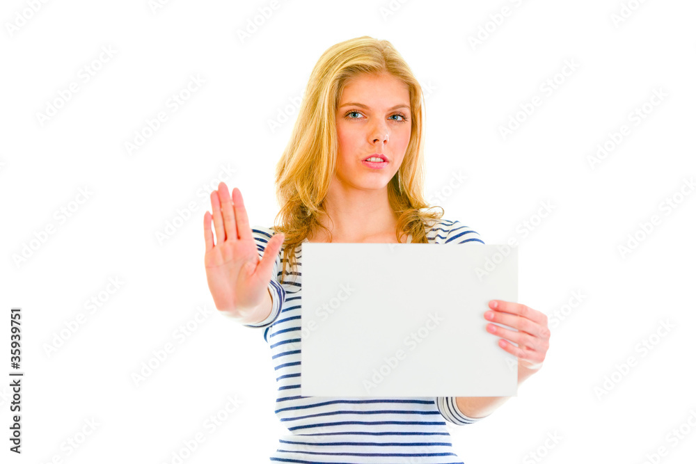Beautiful teen girl holding blank paper sheet and showing stop Beautiful teen girl holding blank paper sheet and showing stop