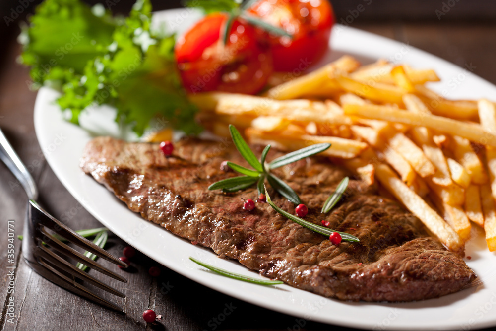 Fototapeta premium Rustic grilled beefsteak with french fries