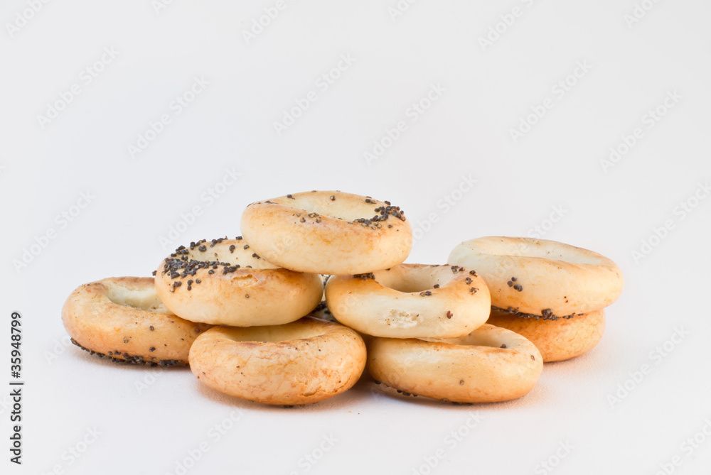 Heap of several bread rings with poppy over gray background Heap of several bread rings with poppy over gray background