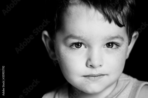 Monochrome portrait of boy with serious expression