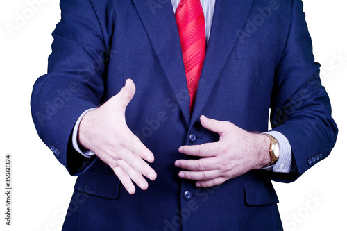 Businessman in suit and red tie handshake.