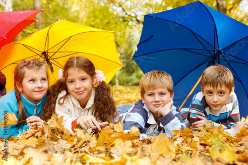 Kids group under umbrellas