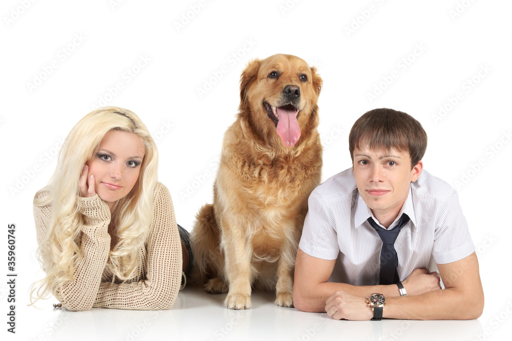 A young family with a dog on floor, looking at camera A young family with a dog on floor, looking at camera