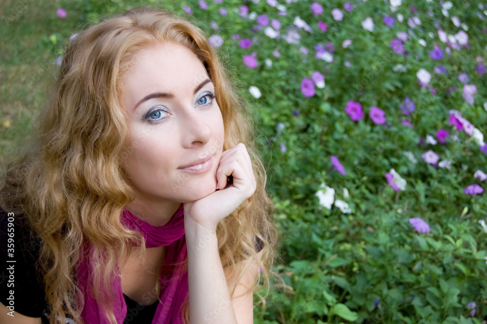 Naklejka premium Woman among violet flowers