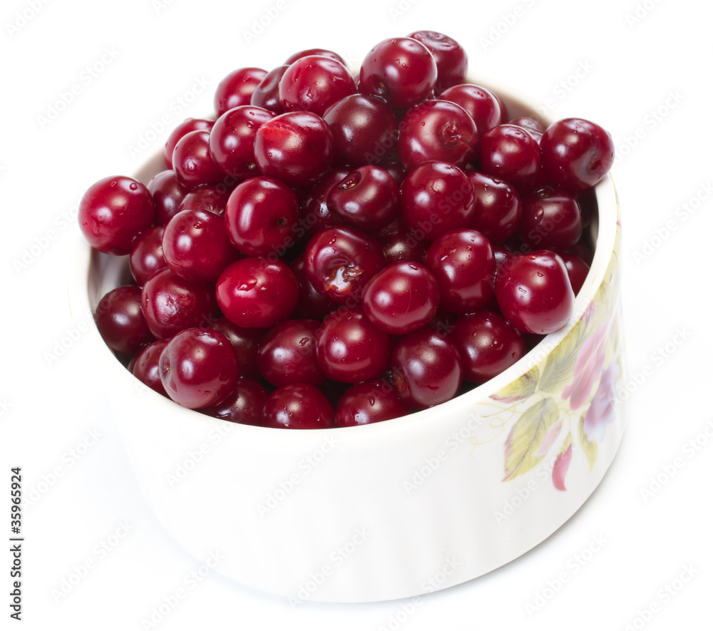 Bowl with ripe cherries. Isolated on a white background. Bowl with ripe cherries. Isolated on a white background.