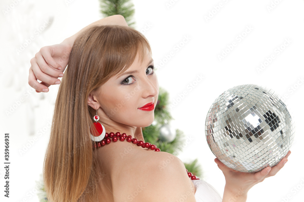 Young woman with mirrored ball near christmas tree. Young woman with mirrored ball near christmas tree.