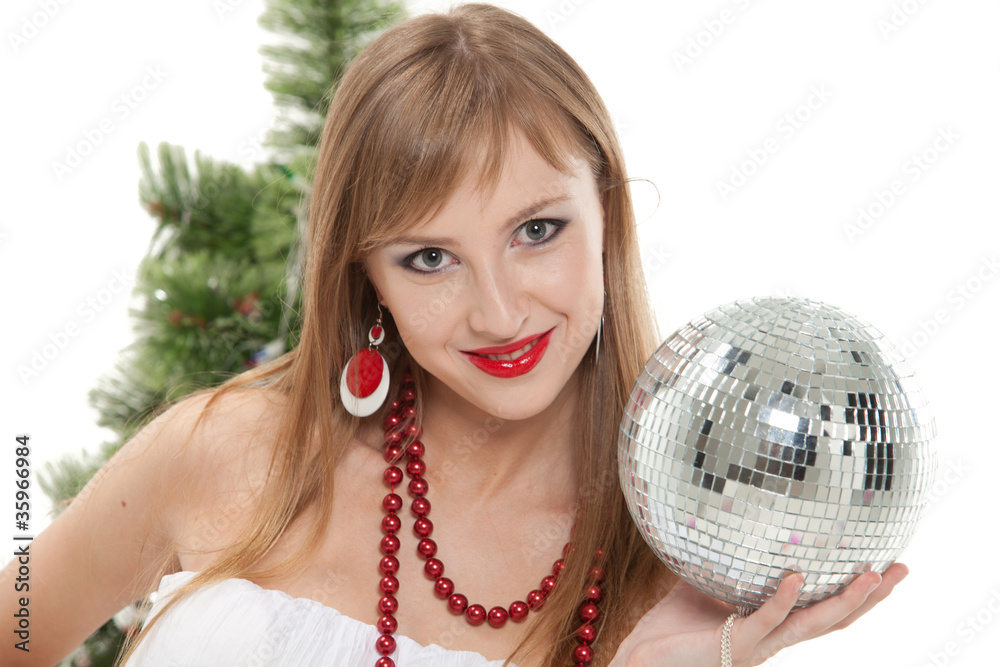 Naklejka premium Young woman with mirrored ball near christmas tree.