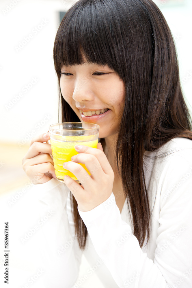 pretty asian woman drinking orange juice pretty asian woman drinking orange juice