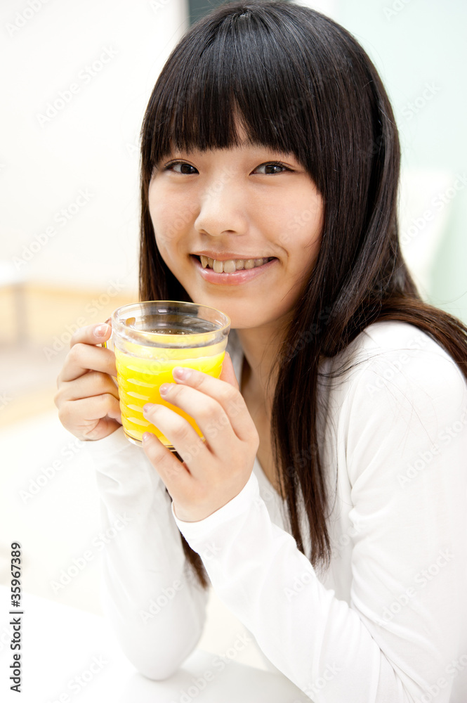 pretty asian woman drinking orange juice pretty asian woman drinking orange juice
