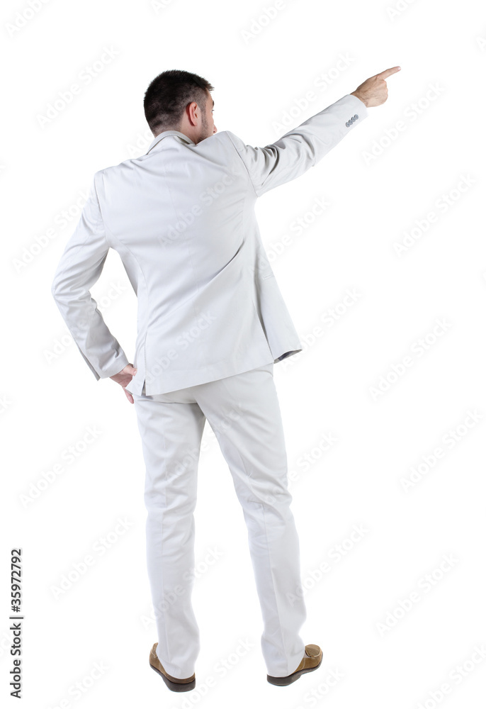 businessman in white suit pointing at wall. rear view.