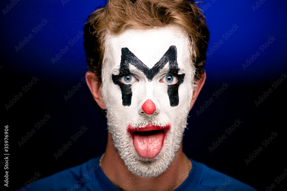 A man with clown makeup on his face A man with clown makeup on his face