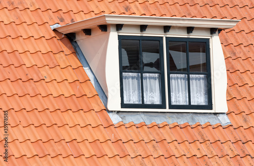 Typical Dutch roof with dormer and squared windows photo