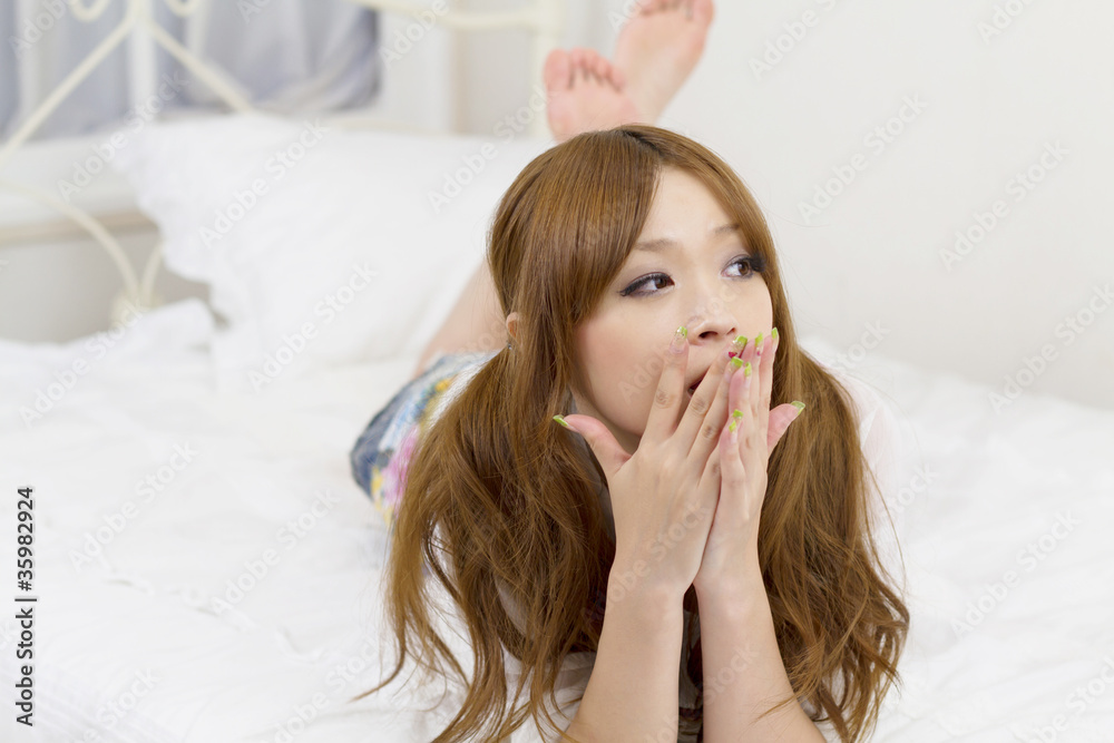 Beautiful asian woman relaxing in bed room Beautiful asian woman relaxing in bed room