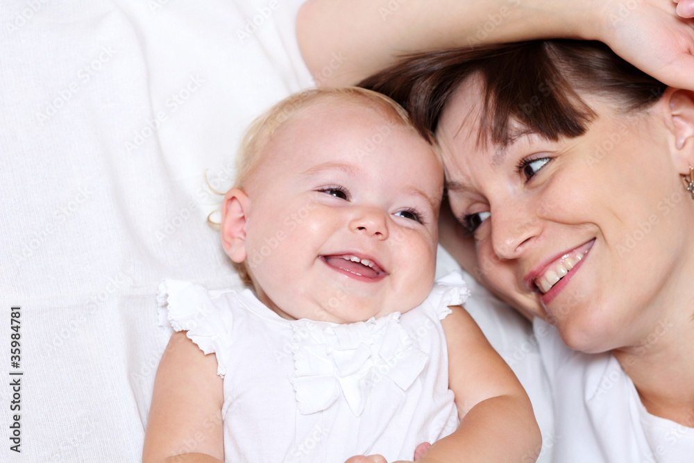 Adorable baby and mother in home