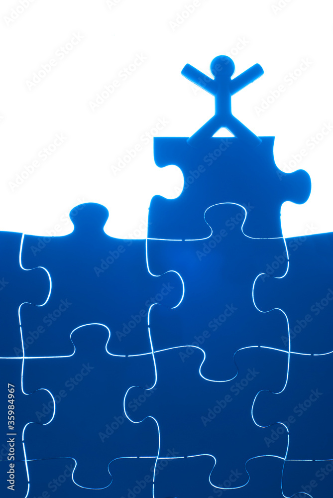 Single person rise hands on top of puzzles. Single person rise hands on top of puzzles.