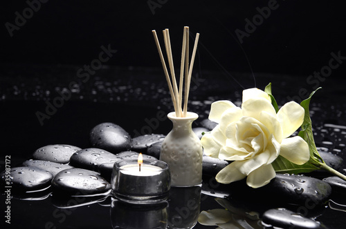 candle with gardenia flower and zen stones