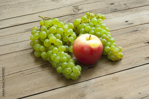 apple and grapes on wooden table