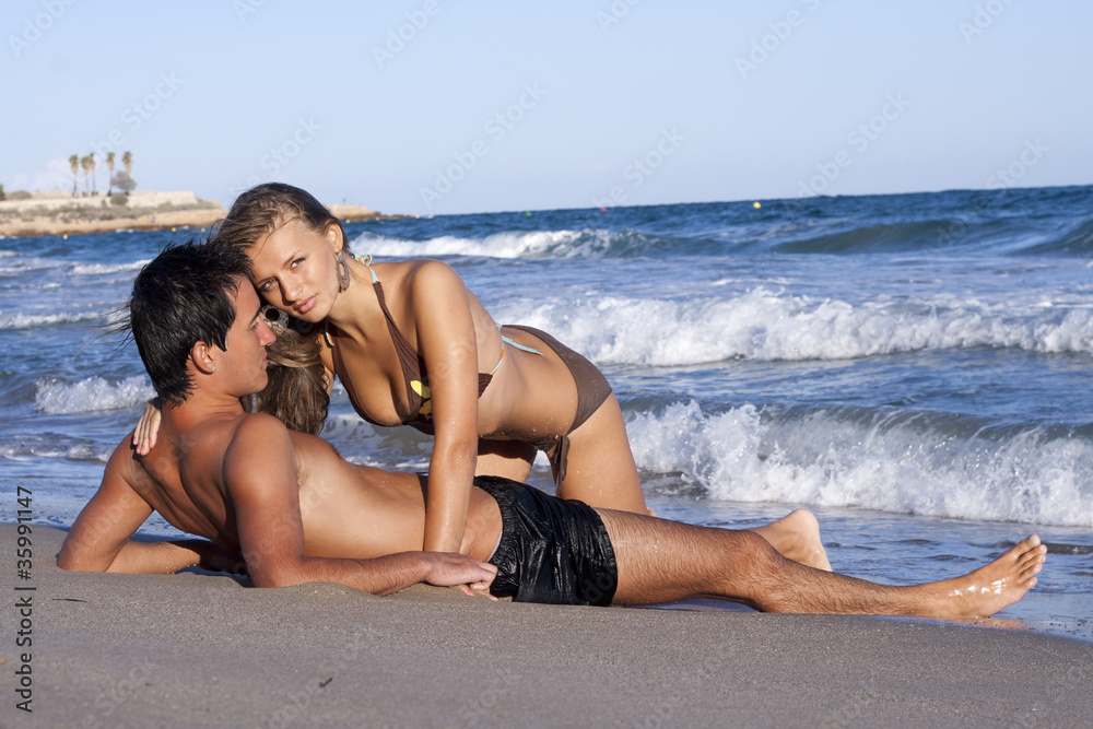 Fototapeta premium young couple relaxing on the beach