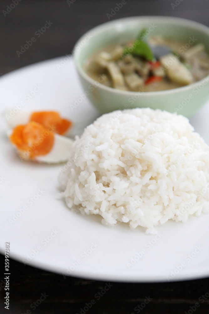 Thai food chicken green curry with rice in wood background Thai food chicken green curry with rice in wood background