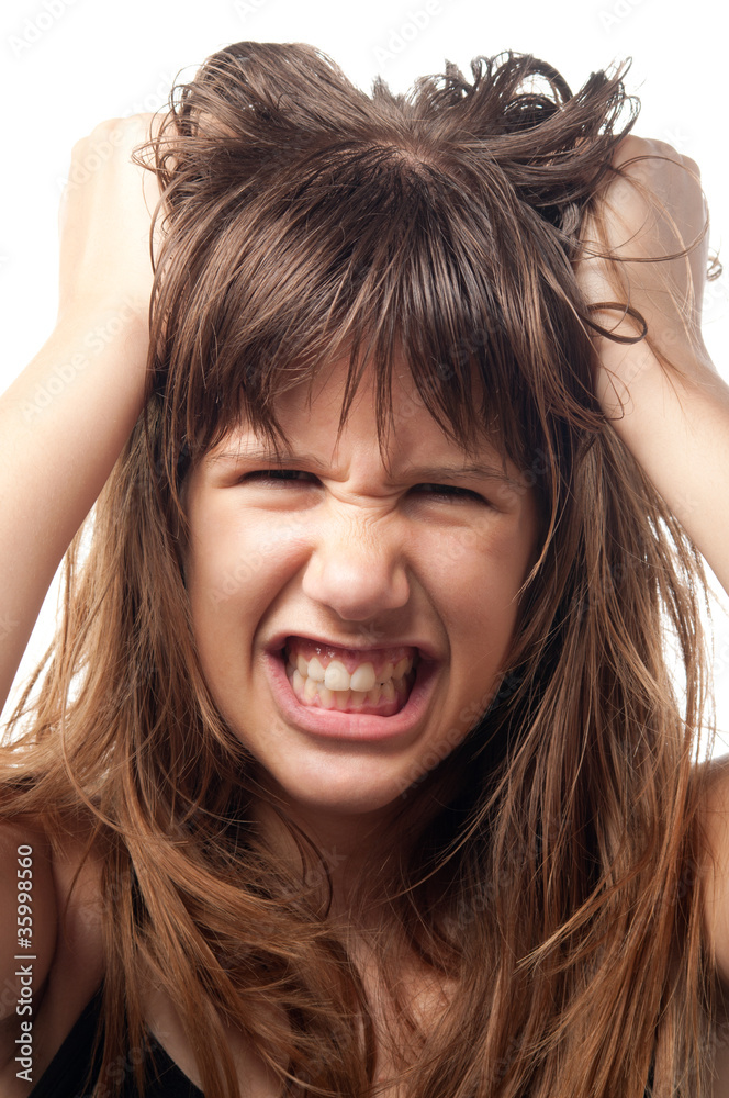 Angry and frustrated teenage girl grinding with teeth. Angry and frustrated teenage girl grinding with teeth.