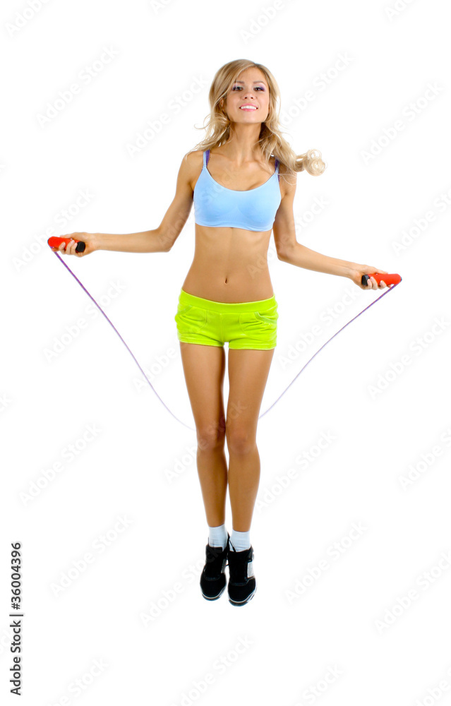 Beautiful sportsgirl with skipping rope isolated on white Beautiful sportsgirl with skipping rope isolated on white