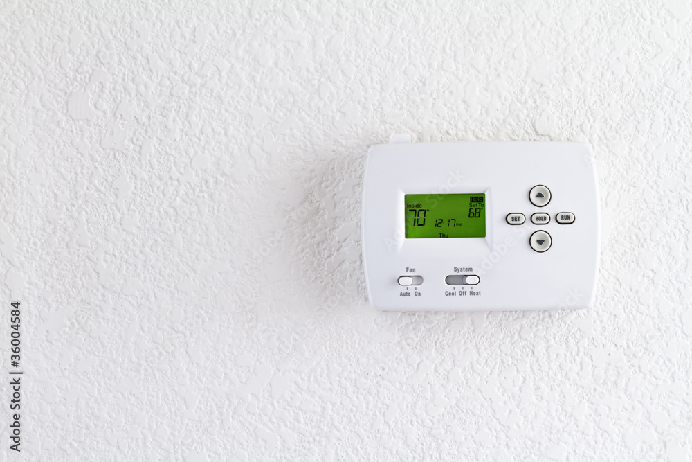 digital thermostat on white wall digital thermostat on white wall