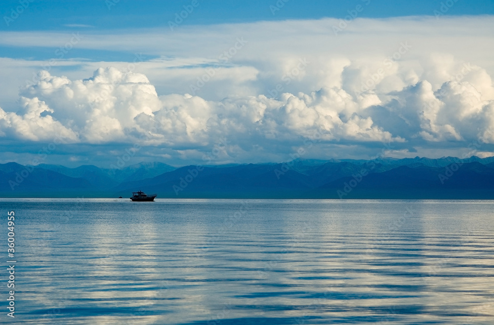 Lake Baikal,the ship against mountains and clouds