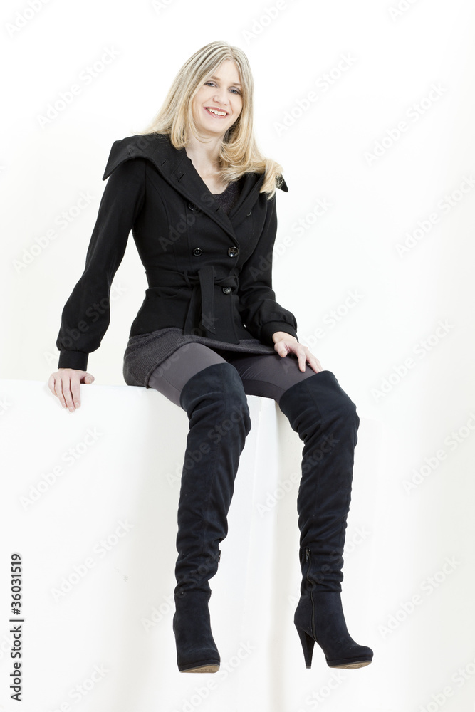 sitting woman wearing fashionable black boots sitting woman wearing fashionable black boots