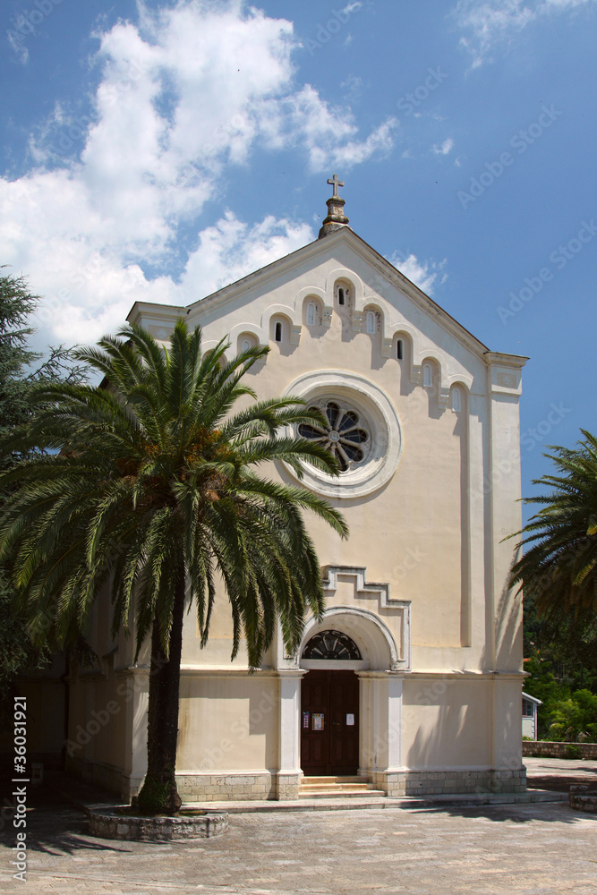 Church and palm on blue sky background