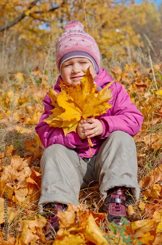 Little girl with yellow leaves