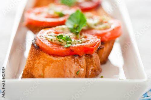 Bruschetta - gold baked baguette with tomato garlic and basil as