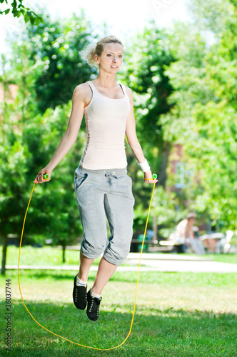Woman with skipping rope at park