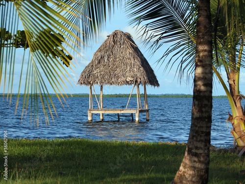 Fototapeta Naklejka Na Ścianę i Meble -  Tropical hut over water with thatched palm roof,  Caribbean sea, Panama