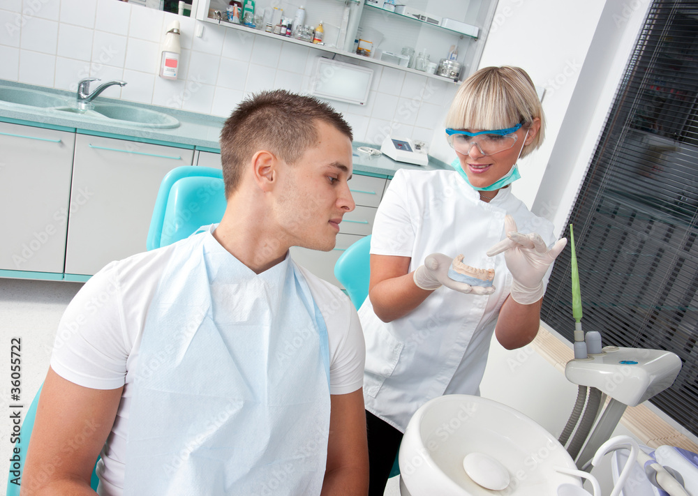 Fototapeta premium dentist showing patient dental protese