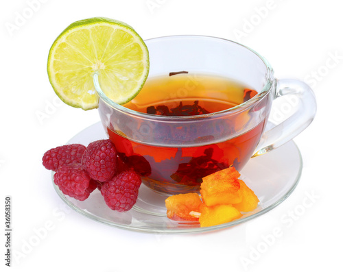 black tea in cup, lime, peach and raspberry isolated on white