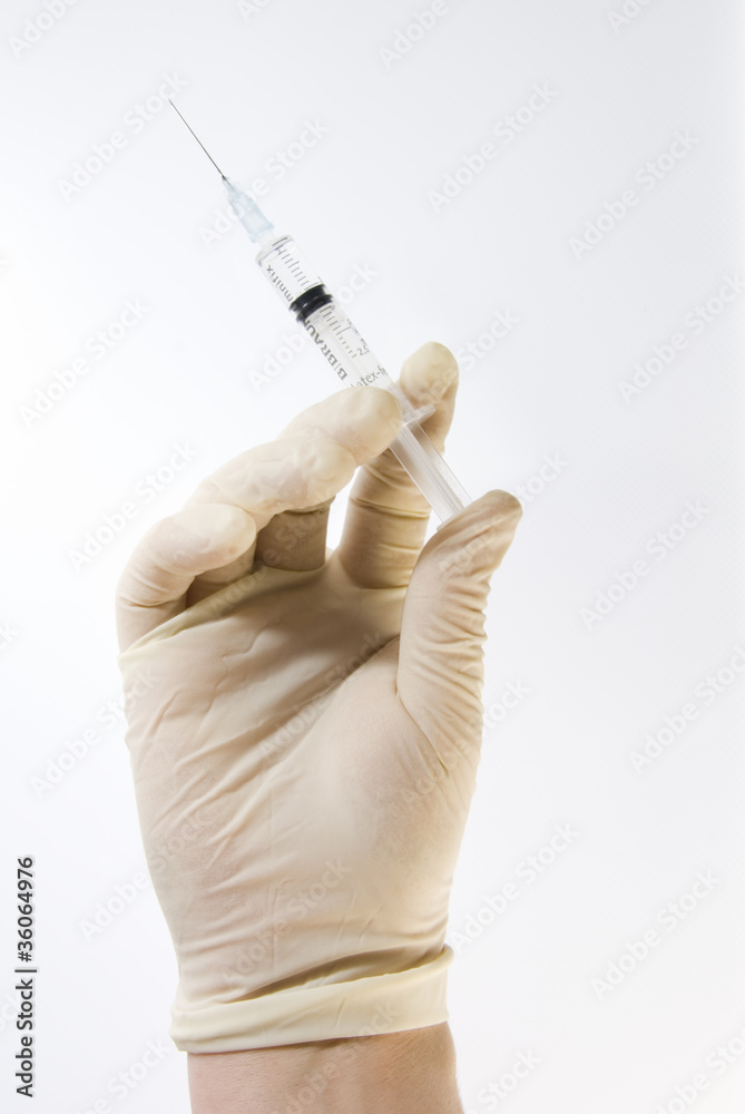 Gloved Hand Holding Hypodermic Needle Gloved Hand Holding Hypodermic Needle