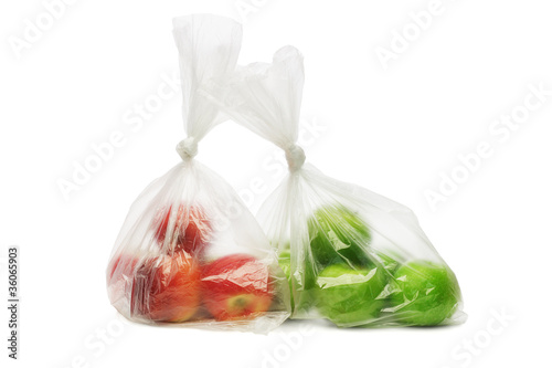 Red and green apples in plastic bags