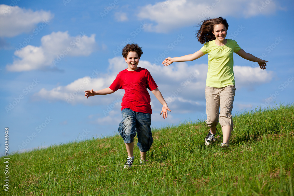 Girl and boy running, jumping outdoor