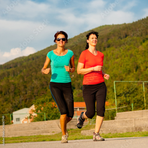 Two young women running outdoor