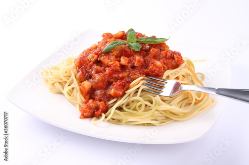 Spaghetti bolognese on a plate being eaten with a fork